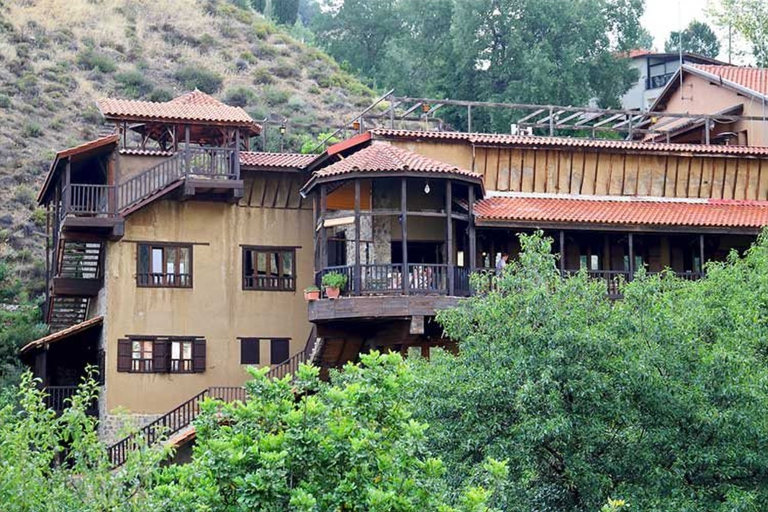 The Mill Hotel building among the trees